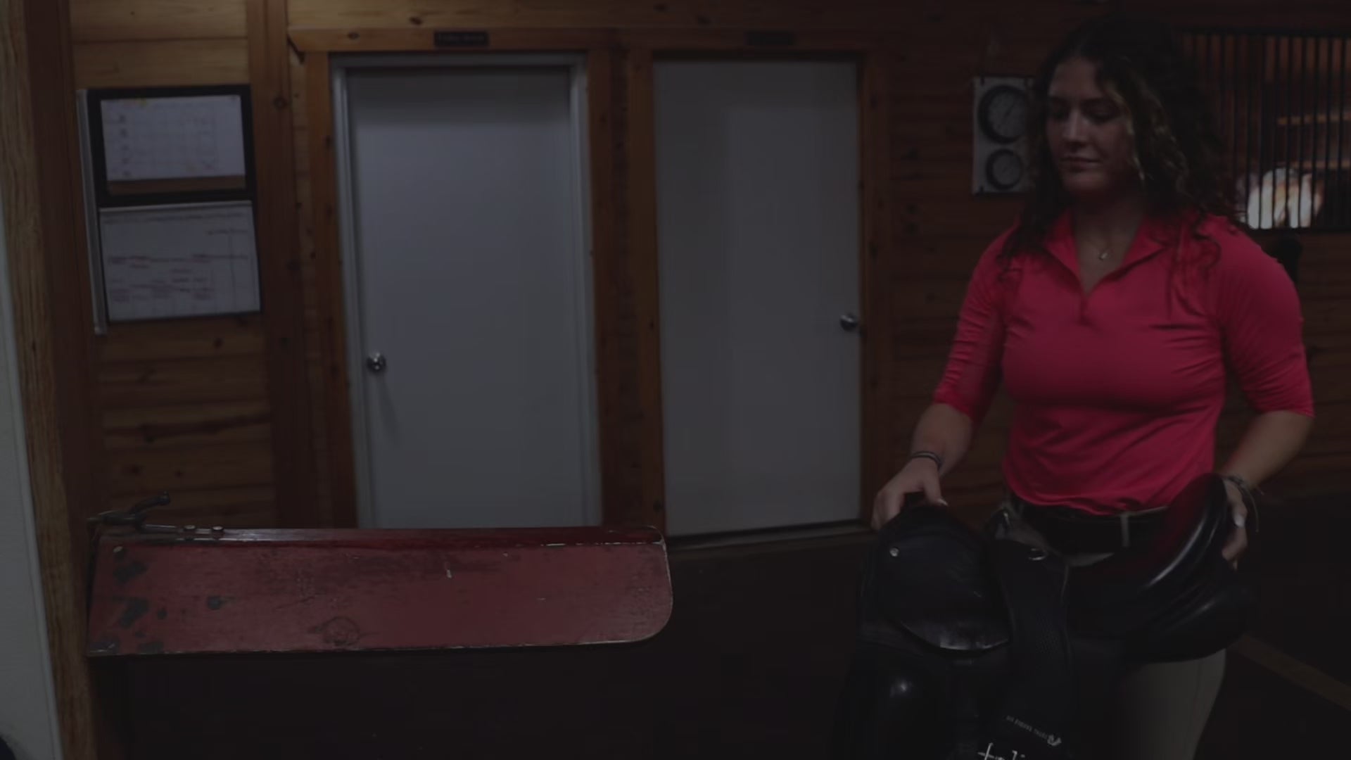 video of girl at barn getting horse ready to ride and smiling